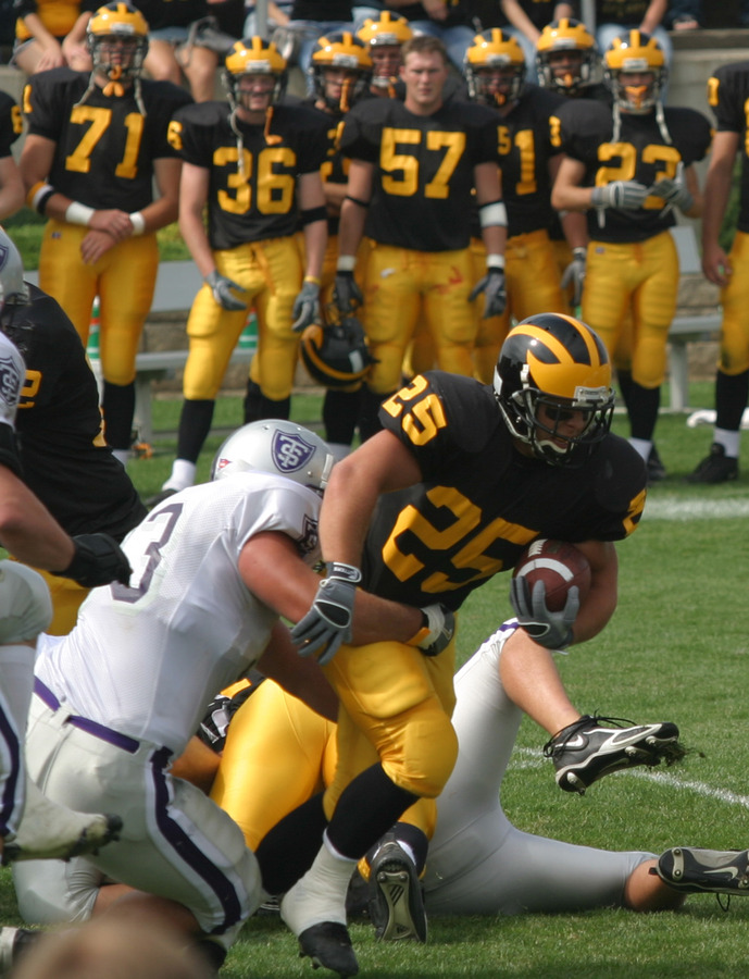 Running back Mitch Anderson busts through the line against St. Thomas.