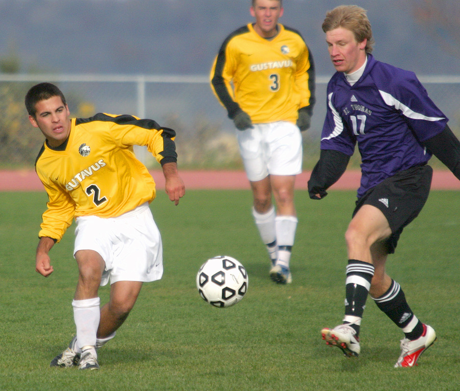 Dan Suchy challenges a Tommie for the ball.