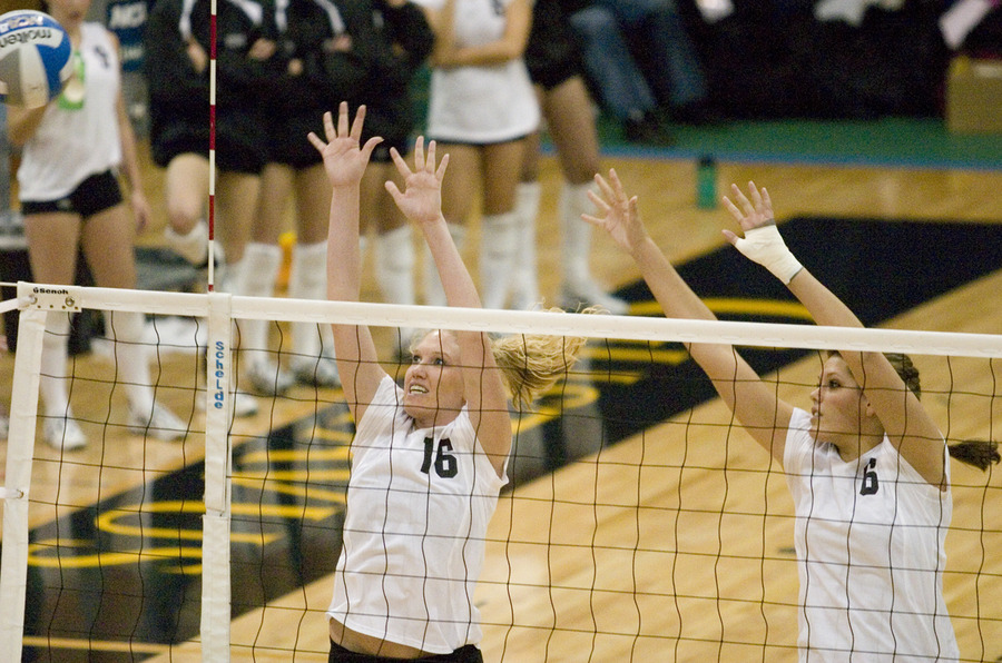 Jessica Plemel (left) and Becca Thompson (right) attempt to block an attack.