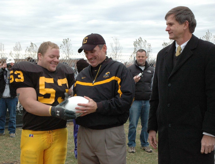 A football, and the tradition it represents, is passed from the current stadium to the location of the new field.