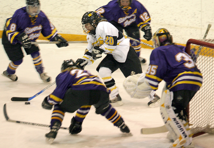 Molly Doyle pushes the puck through a sea of Pointer defenders near the net.