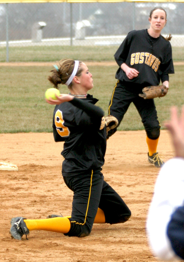 Shortstop Rachael Click throws out a runner from her knees in game one. 