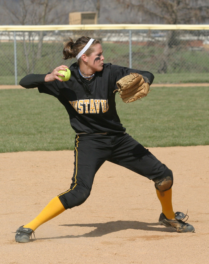 Shortstop Rachael Click sets and throws to first base for the out.