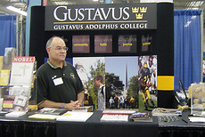 Al Behrends from the Office for College Relations eagerly awaits visitors at the Gustavus state fair booth.