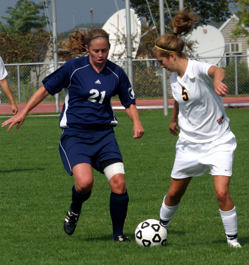 Becca Hagen works  to keep the ball from a Carleton player.