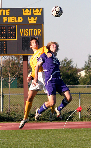 Mike Butterworth and Reid Moser-Bleil jump for the header.