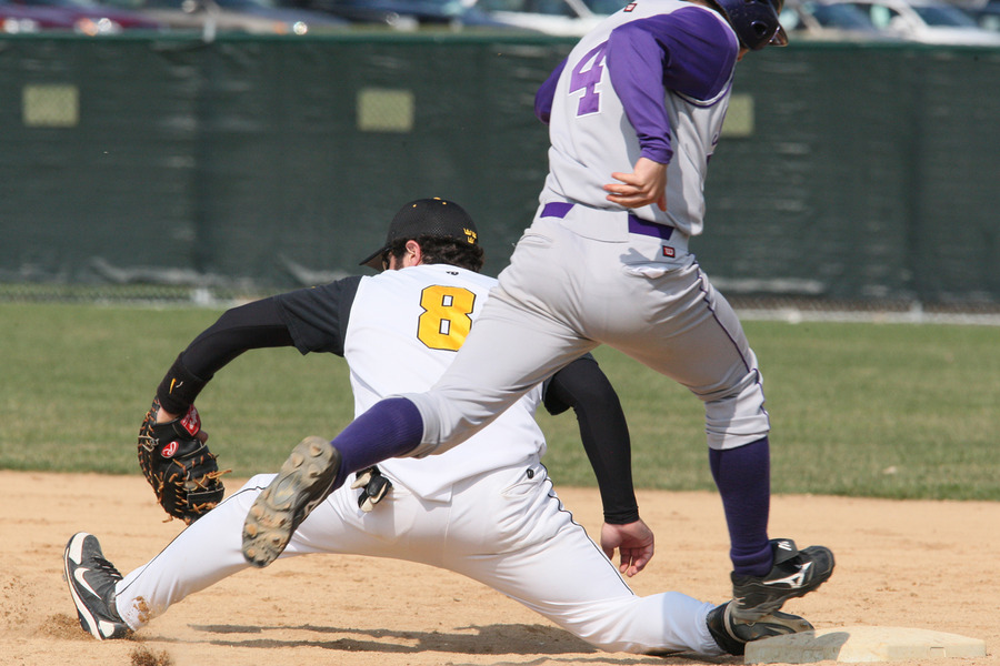 Pat Siering stretches to nip a St. Thomas baserunner at first base in game one. (Brian Fowler Photo)