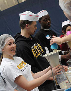 Students and others package meals during the 2008 Building Bridges Conference. (Photo by Tom Roster)