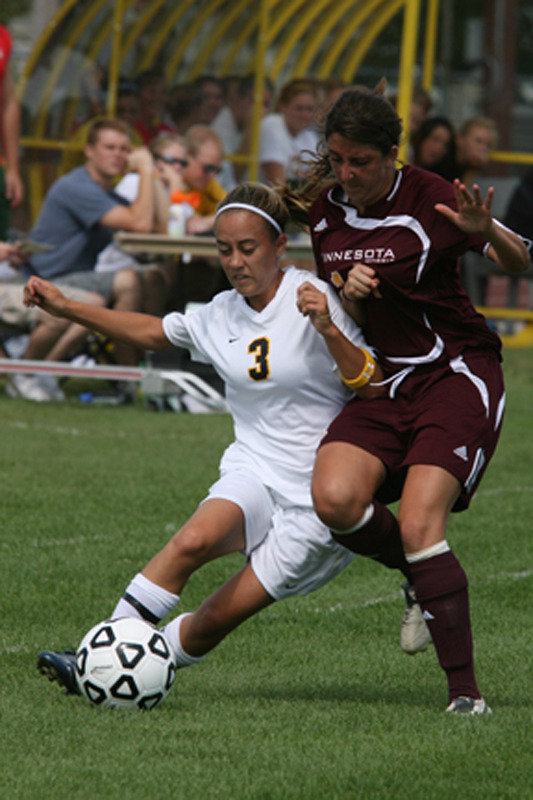 Mackenzie Del Santro protects the ball from a UM-Morris defender.