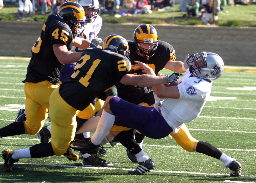 The Gustavus defense stops a St. Thomas player.