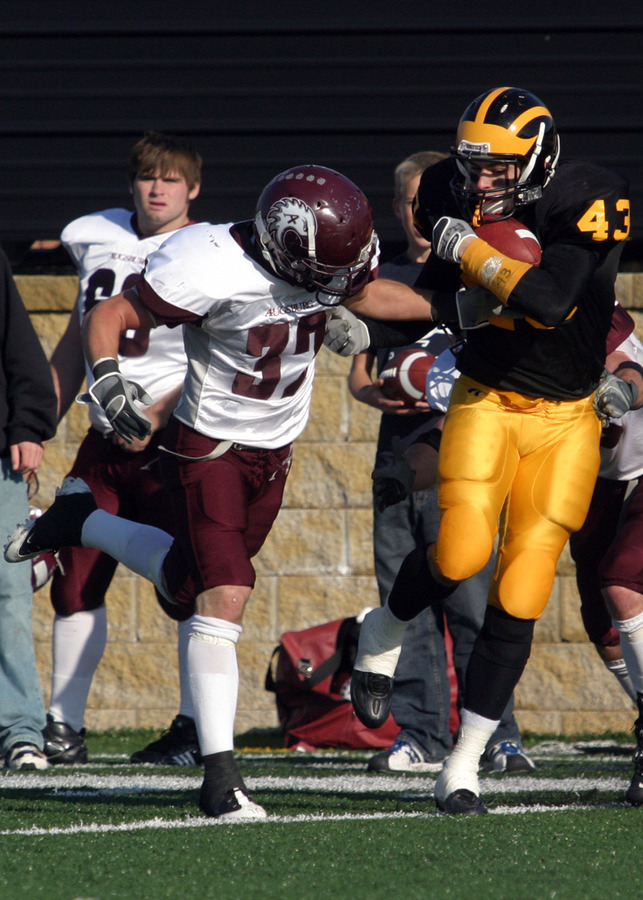Senior Chad Arlt makes the catch between two Augsburg defenders.