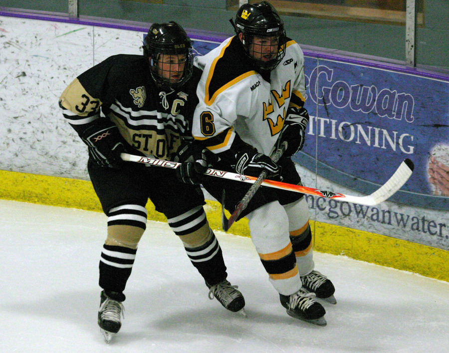 Cody Mosbeck and Sam Windsor battle for position as they head to the puck.