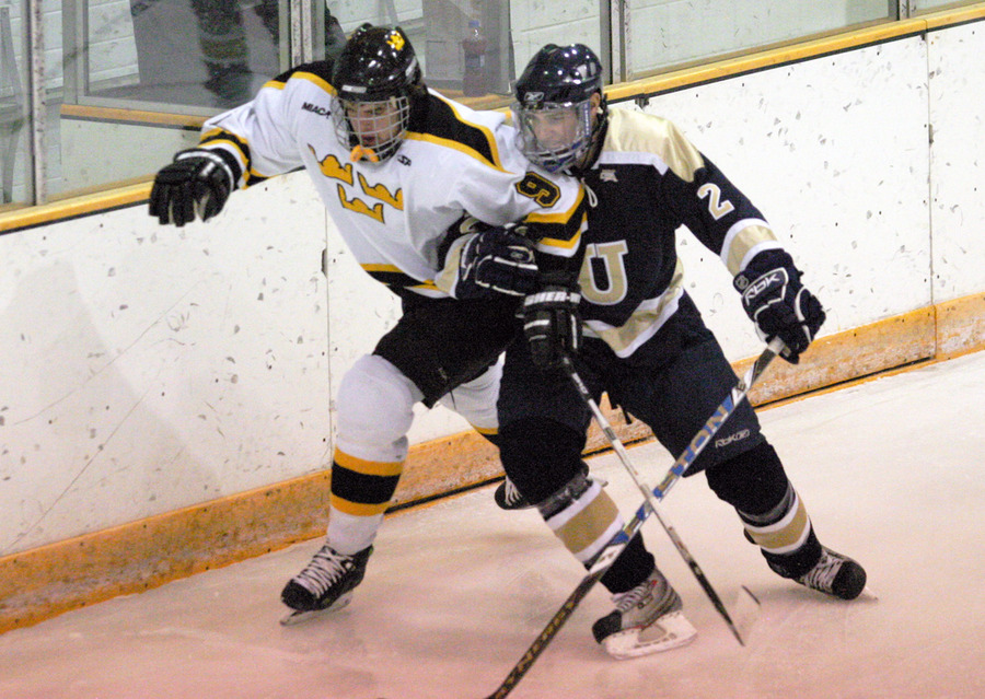 Two skaters fight for position for the puck.