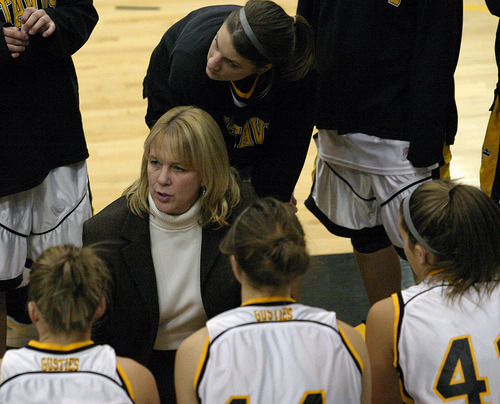 Head Coach Mickey Haller talks to the team in the huddle during a timeout.