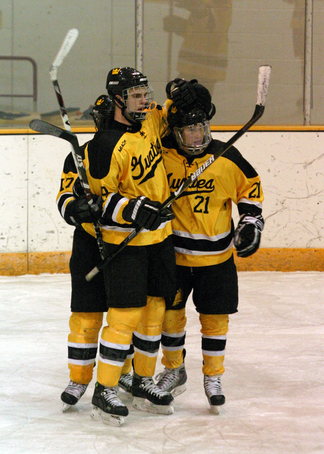 Eric Bigham, Joe Welch, and James Leathers celebrate after a goal.