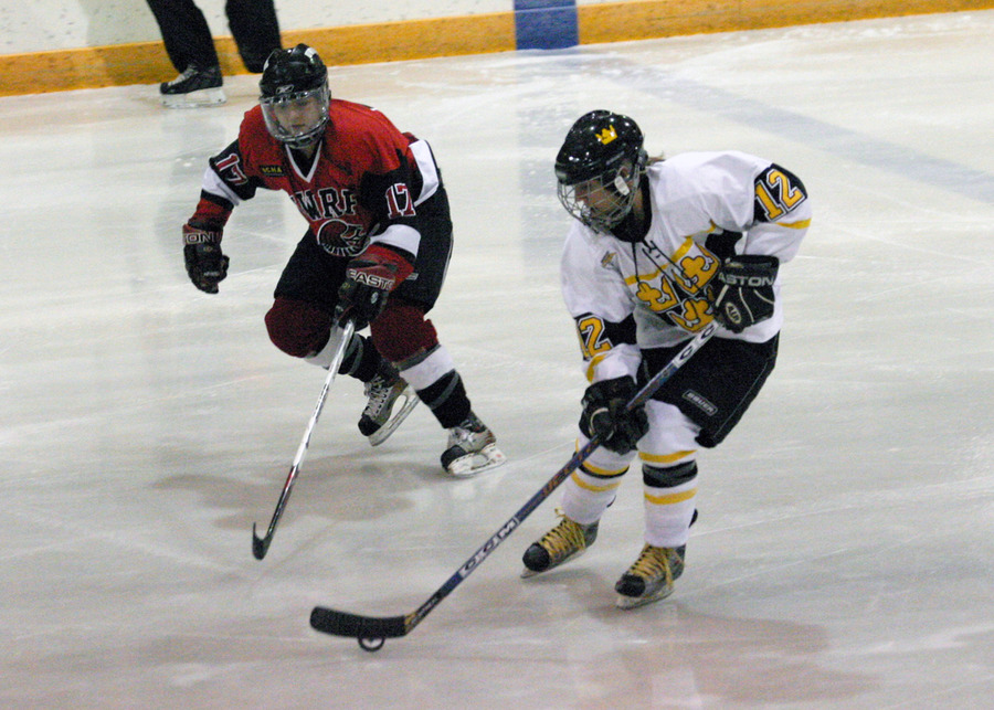 Jessie Doig skates the puck into the Falcons zone.