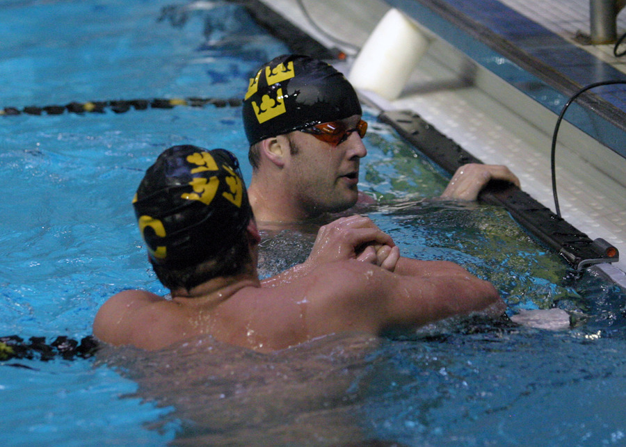 Casey Enevoldsen (facing) is congratulated by John Rice (back to photo).