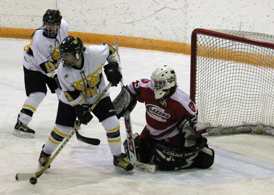 Lynn Hillen controls the puck right in front of the St. Ben’s net while Alyssa Gaulrapp covers the back post.