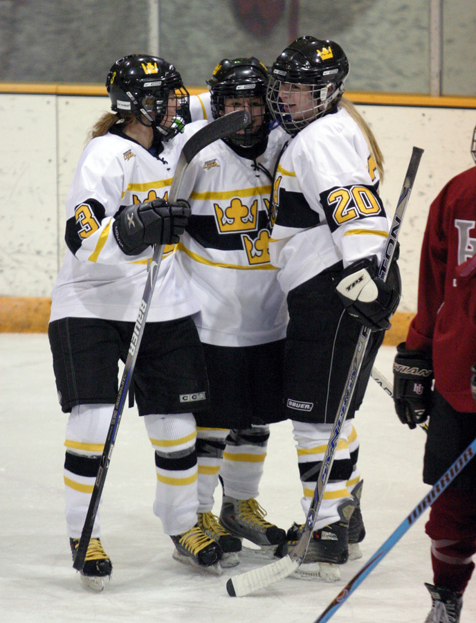 Gina DeNucci (left), and Gracie Olson (right) celebrate with Christine Wcker (center) after Wicker scored the first goal.