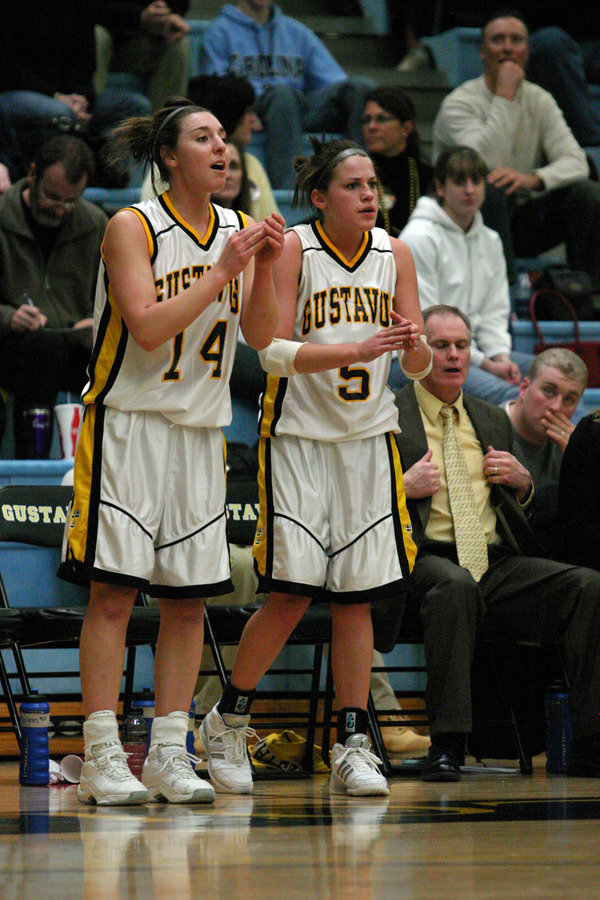 Julia Schultz (left) and Bri Radtke (right) cheer their teammates from the sideline.