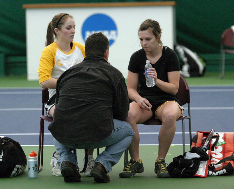 Coach Jon Carlson talks to Ali O’Neal (left) and Erica Dobson during their #2 doubles match.