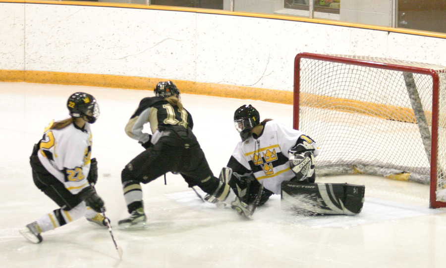 Danielle Justice stops a breakaway attempt by Kayla Hill of St. Olaf.