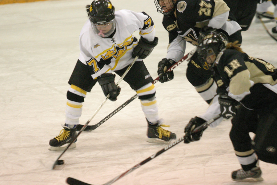 Kathryn DelZoppo attempts to clear the puck for Gustavus.
