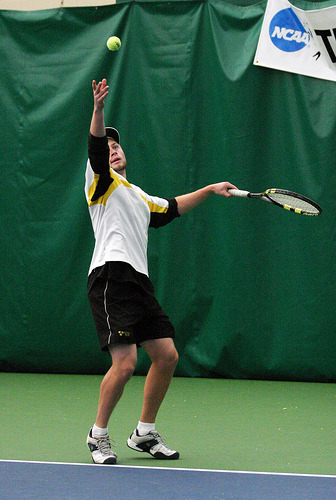 Mike Burdakin tosses up the ball for a serve against UW-Whitewater.