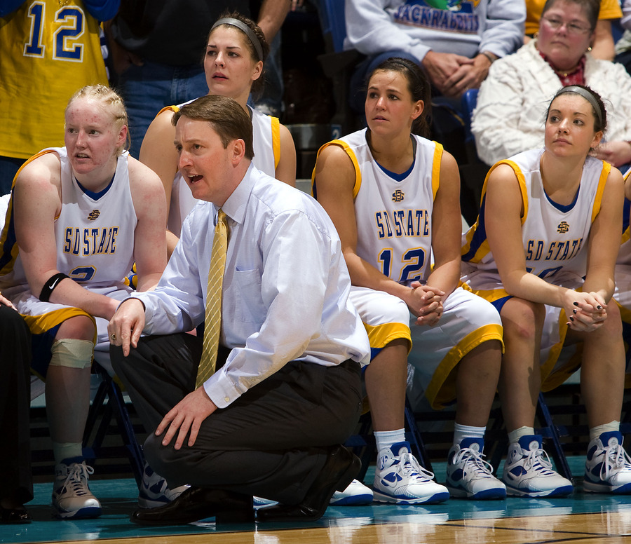 Aaron Johnston ‘96 on the sidelines during the Summit League Tournament. (Photo courtesy of SDSU Athletics)