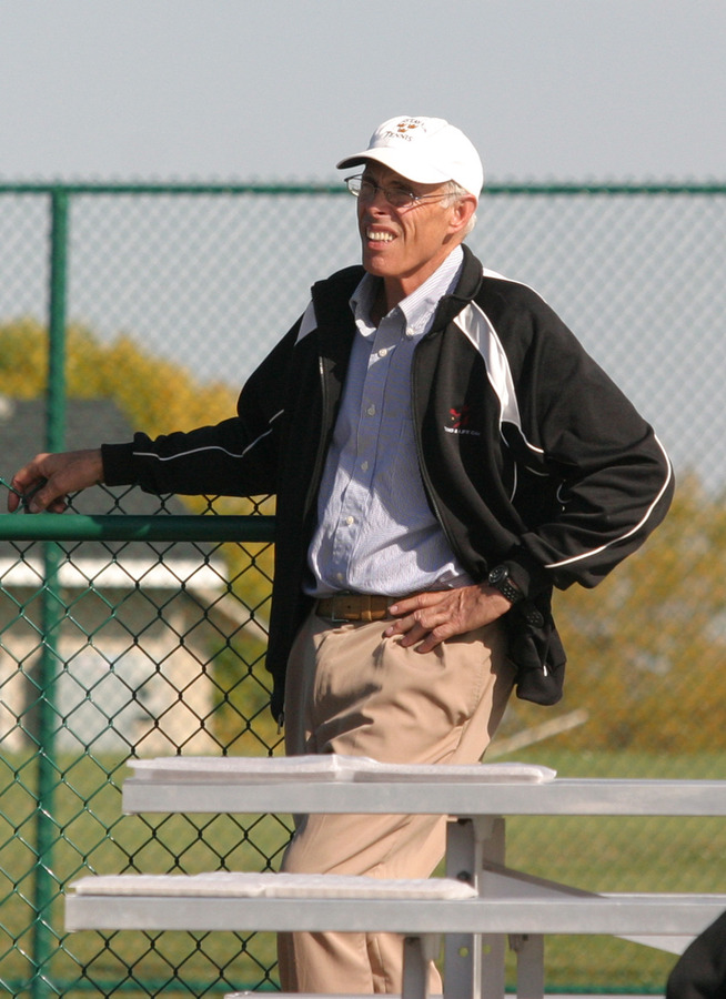 Coach Wilkinson watching a match at the Brown Outdoor Courts.