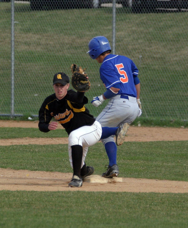 Tory Herman keeps his foot on first base as the throw just beats the Macalester runner.