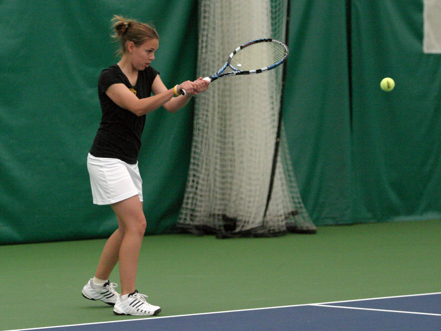 Marianne Barau drives a backhand over the net in her #5 singles match.