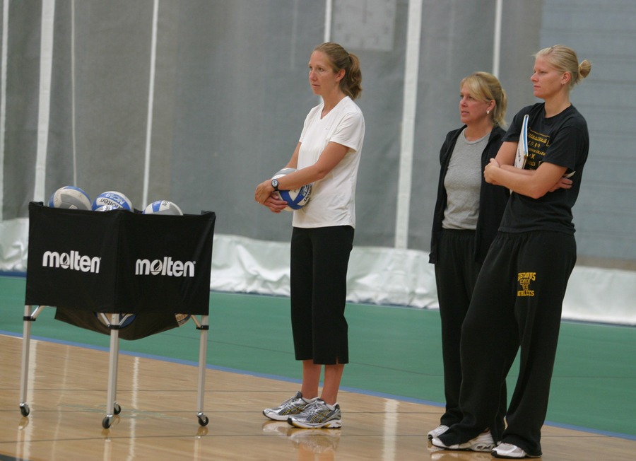 Head Coach Kari Eckheart (left) watching practice with assistants Mickey Haller (center) and Jen Thelemann (right).