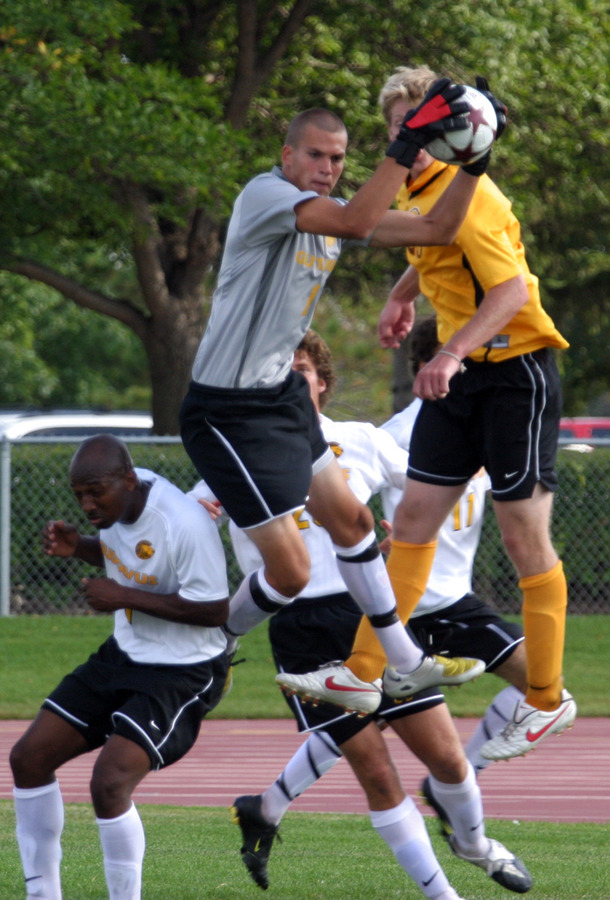 Luke Strom goes up high for a save for Gustavus.