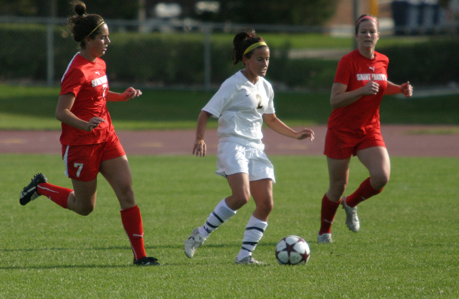 Kirsten Thulien dribbles past two Saint Mary’s defenders.