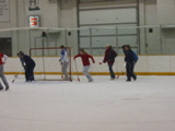 Behind the net.