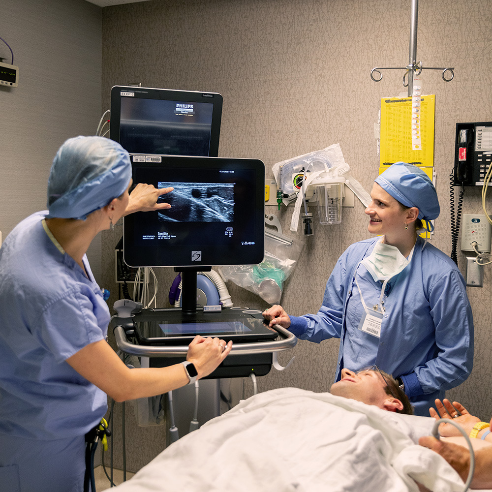 Gustie students interacting with Mayo doctors in an operating room.