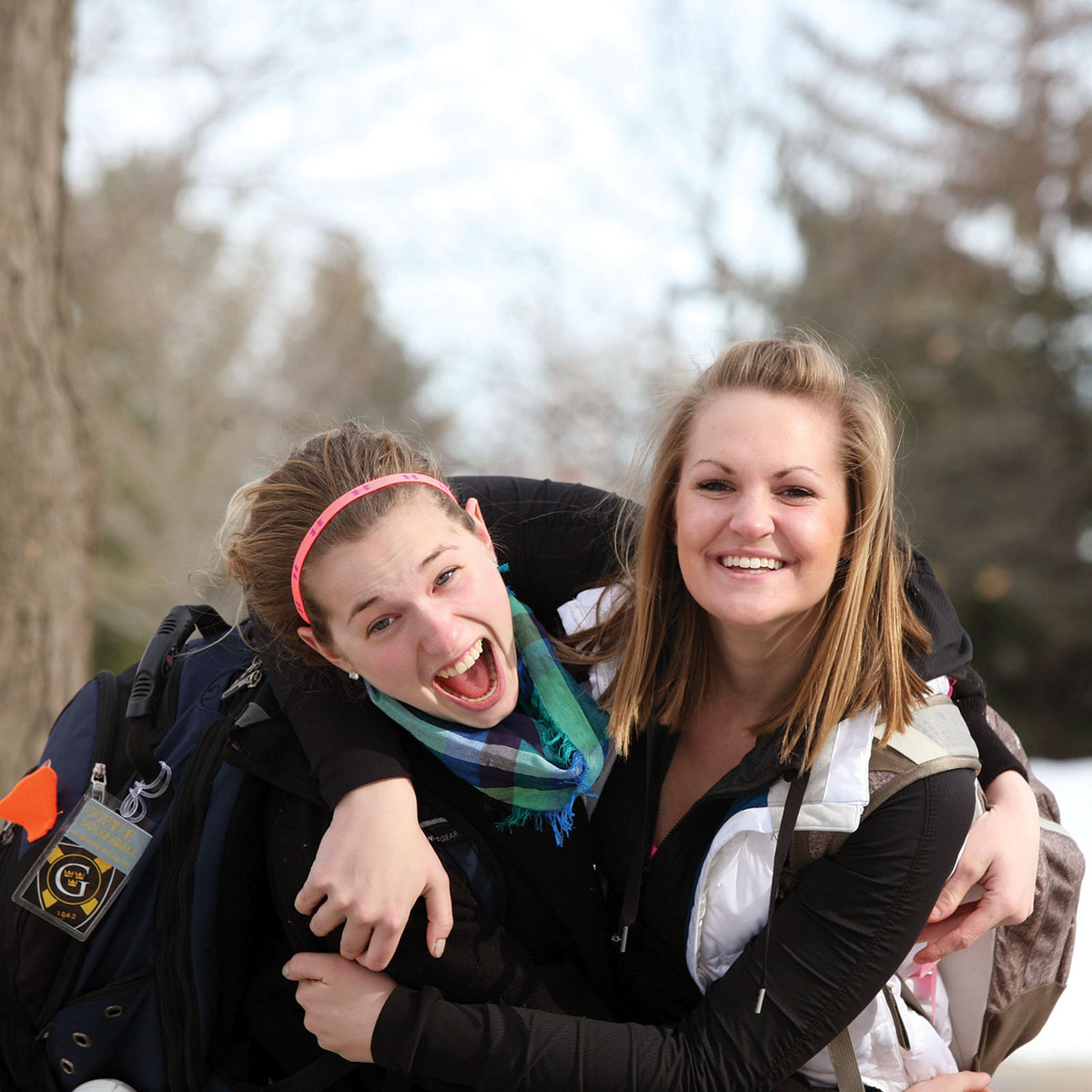 Gusties hugging outside in the snow.