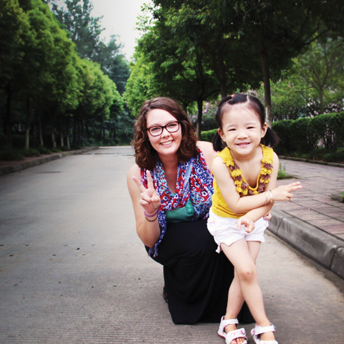 Gustie in the Peace Corps with a child.