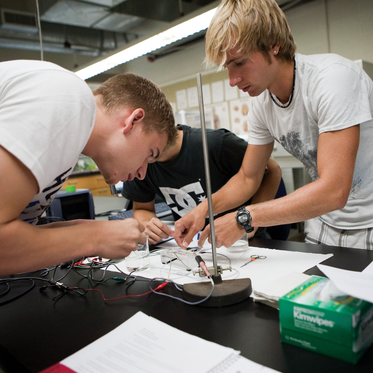 Two men at a lab station.