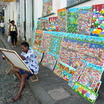 Photo gallery image named: painter_displays_his_wares_in_the_streets_of_salvador_-_brazil.jpg
