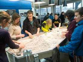 Students both learn and play in the museum's stream table.