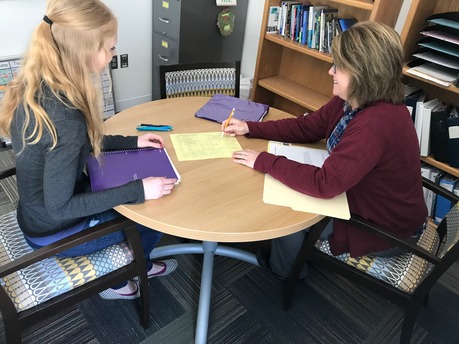 Here is a photo of Kim Meyer meeting with a student about getting started in the Education Department. 