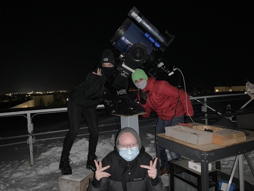 Observatory assisstants doing a candid pose around a Meade LX600 telescope on the observatory platform.