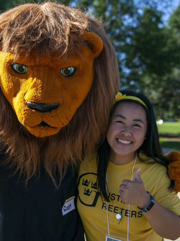 Gus the Lion with a student.