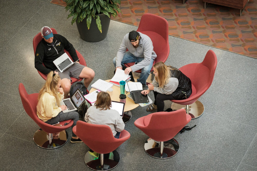 A group of students studying in the Beck Hall atrium.