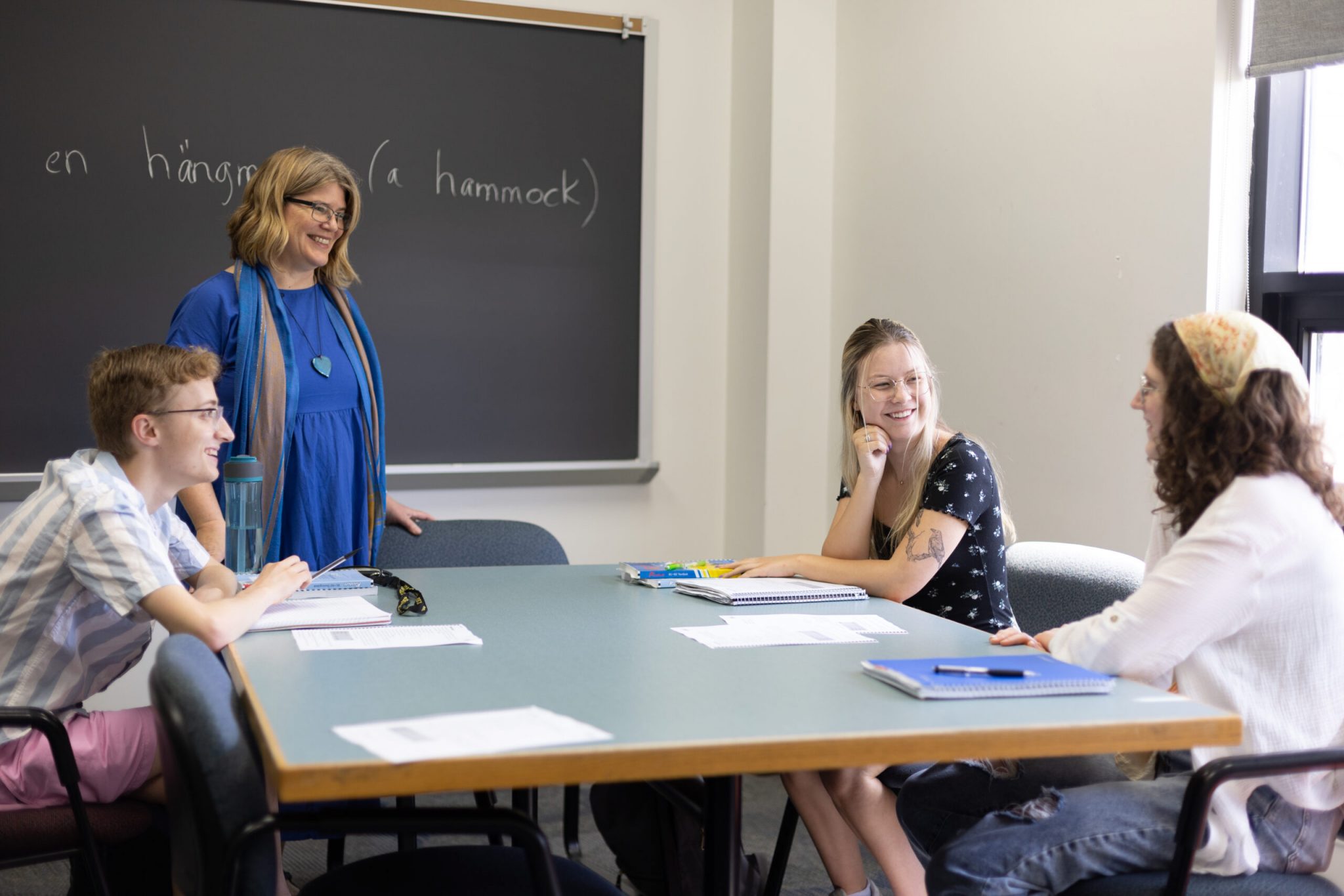 Scandinavian Studies professor chats with students in classroom setting