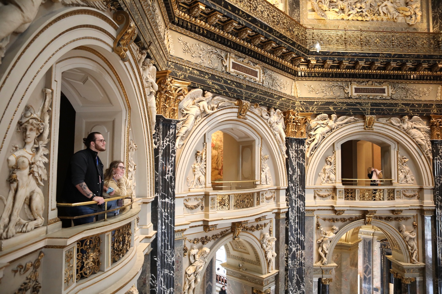 Two young people gaze out upon a Vienna art museum.