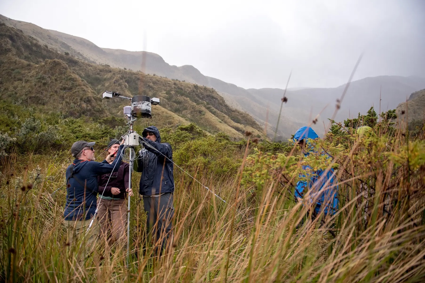 Students and professors work on weather recorders. 