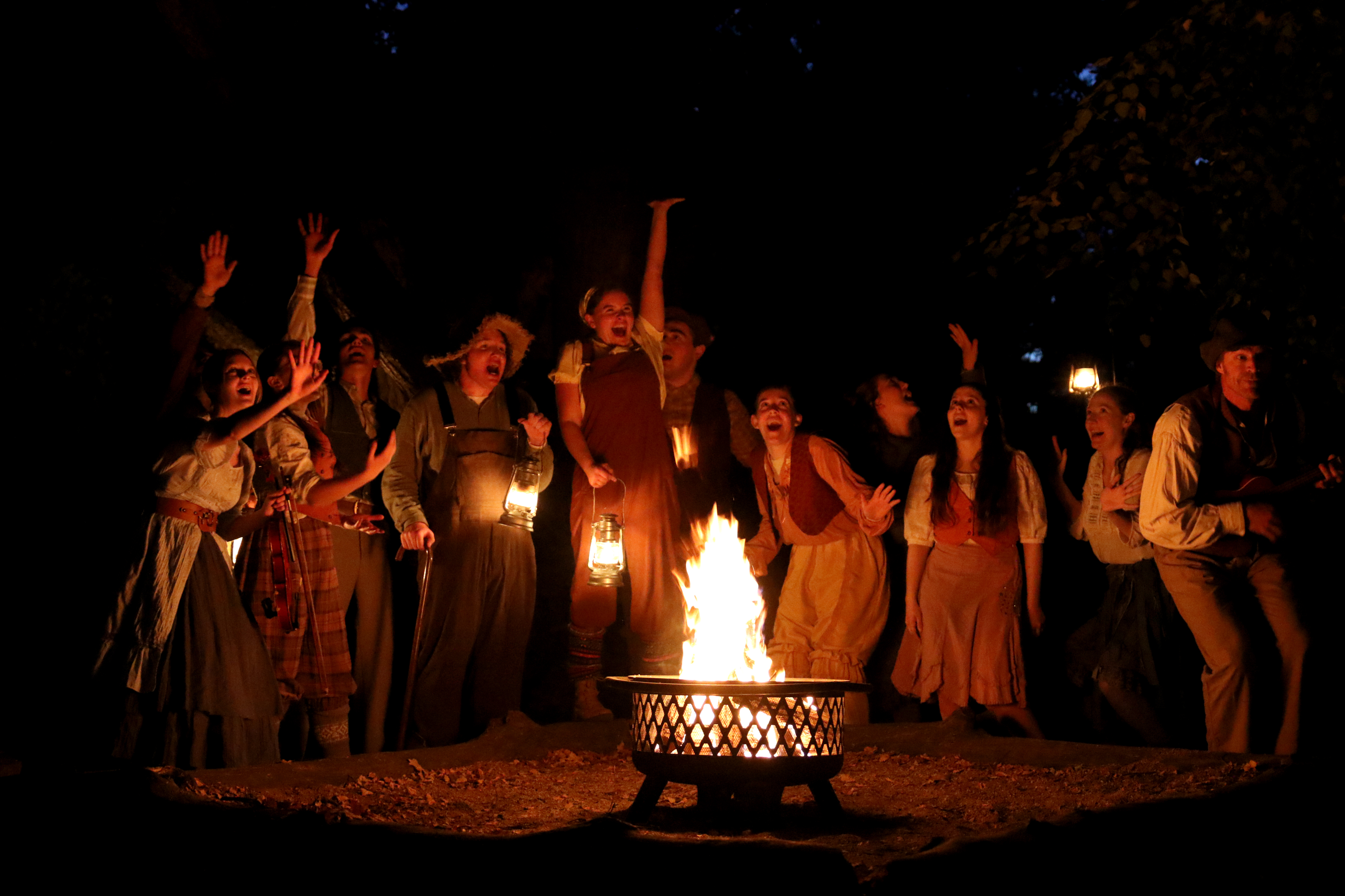 Excited people around a bonfire